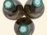 three bottles of beer sitting next to each other on a table
