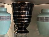 deux vases posés sur une étagère en verre dans une vitrine