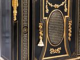an antique black and gold painted cabinet with a marble top