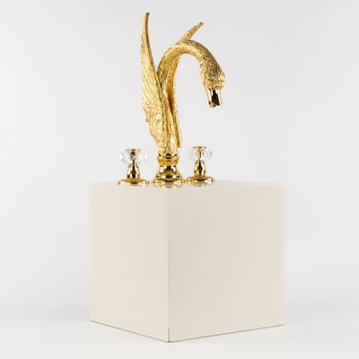 an image of a golden bird statue on a white pedestal