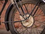a close up of a motorcycle tire with a brick wall in the background