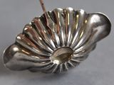 a silver object with a stick sticking out of it