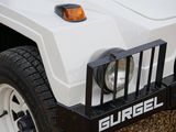 a close up of a white hummer truck parked on a gravel lot