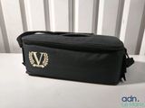 a black bag that has a gold v on it