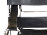 a black leather and chrome chair on a white background