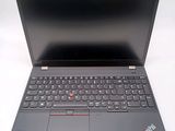 a close up of a laptop with a keyboard on a white surface