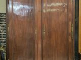 a large wooden cabinet with a mirror on top of it