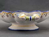 a white bowl with blue and yellow designs on it
