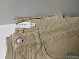 the back of a pair of tan pants with a label on it