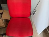 a red office chair that is sitting on the floor