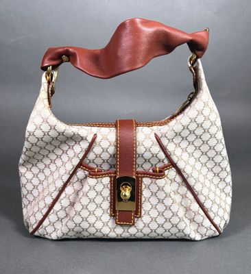a white and brown handbag with a brown handle