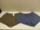 two pairs of men ' s underwear sitting on a white table