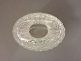 a clear glass bowl with a silver lid on a table