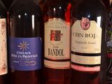 several bottles of wine are lined up on a shelf
