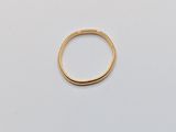 a close up of a gold ring on a white surface