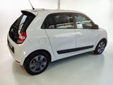 a picture of a small white car parked in a garage