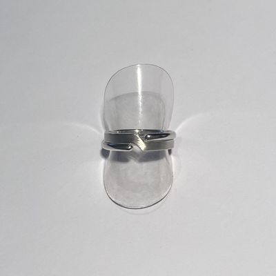 a clear glass with a silver ring on top of it