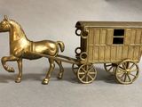 a gold horse pulling a carriage with a man in it