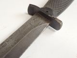 a close up of a knife on a white surface