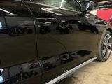 a black car that is parked in a garage