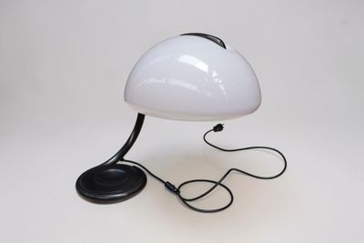 white table lamp with a black base and a black cord