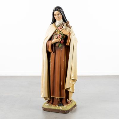 the statue of a woman holding a cat is standing in a room
