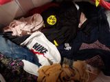 a pile of clothes in a box on the floor