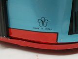 a close up of a red and blue car with a flower on it