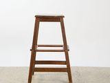 an image of a wooden stool sitting on top of a white floor