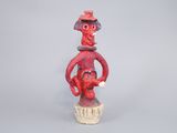 figurine of a man with a hat on his head