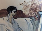 a vase with a picture of a woman sitting on a couch