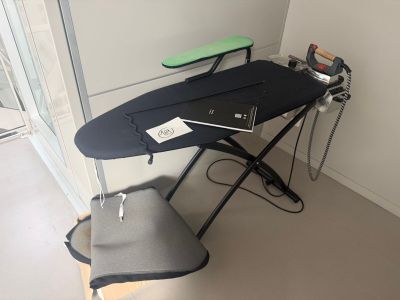 a black ironing board sitting on top of an ironing board