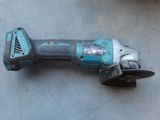 an image of a corded drill is laying on the ground