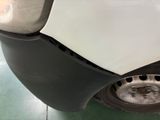 a close up of a car ' s front bumper and tire