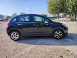 a picture of a small black car parked in a parking lot