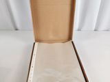 an open box with a piece of paper in it sitting on a white surface