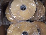 three rolls of wax are wrapped in plastic in a cardboard box
