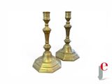 pair of antique brass candlesticks on a white background