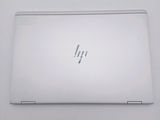 the back of a white laptop computer sitting on top of a white table