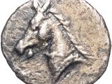 a close up of a coin with a horse on it