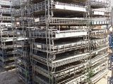 a large pile of scaffolding in a parking lot