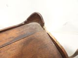 a wooden bench that has a wooden seat on it