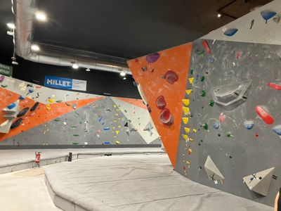 an indoor climbing gym with a rock climbing wall