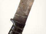 someone is holding a knife with a black handle on a white surface