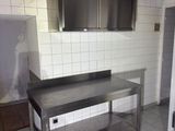 a kitchen with stainless steel counter tops and cabinets