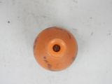 a small orange vase sitting on a white surface