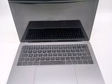 a silver laptop computer sitting on top of a white table