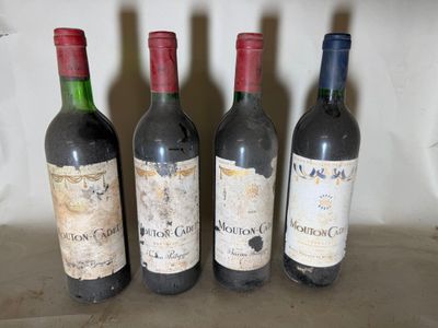 four bottles of wine are lined up on a table