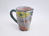 a picture of a ceramic pitcher with a design on it