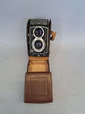 a brown leather case with a camera inside of it